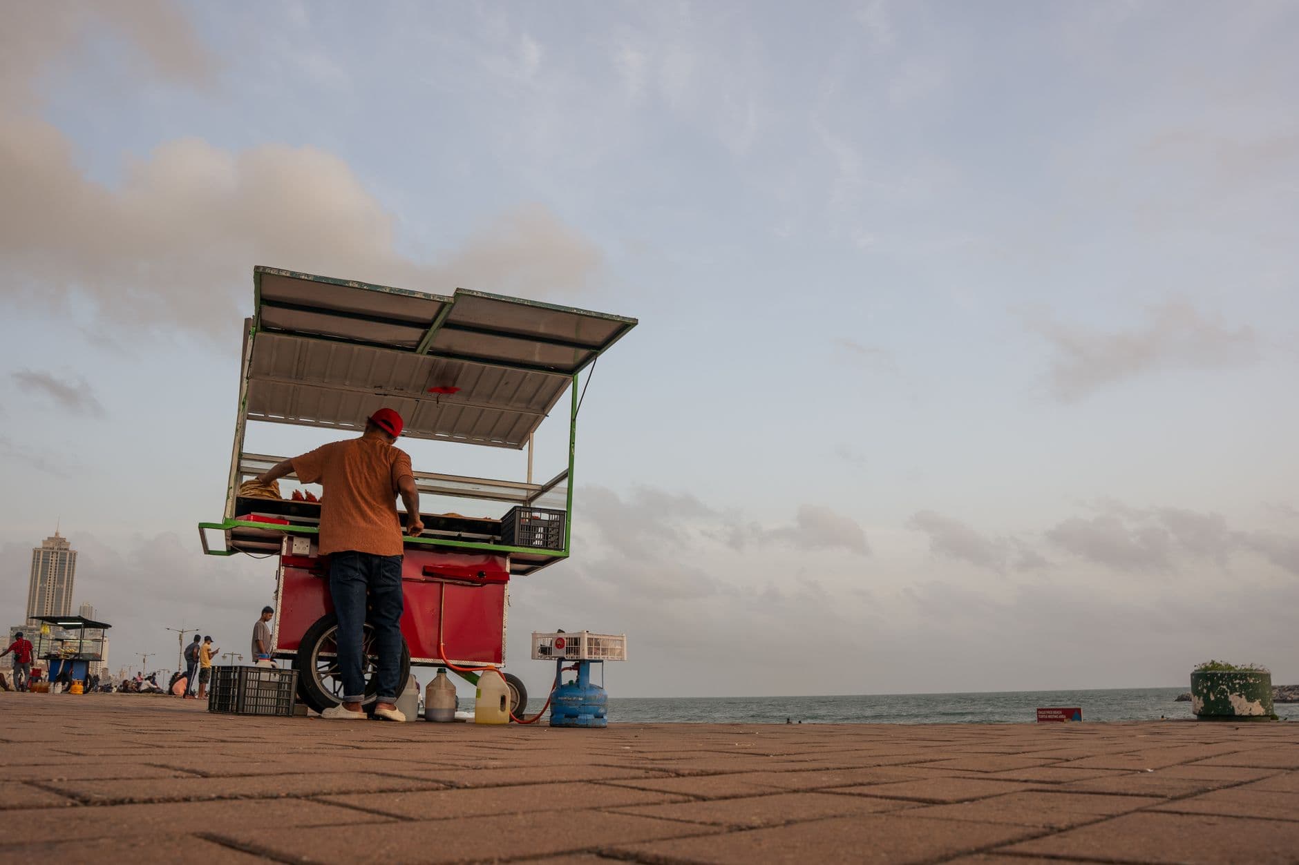 A street-food cart on the Galle Face seafront at dusk