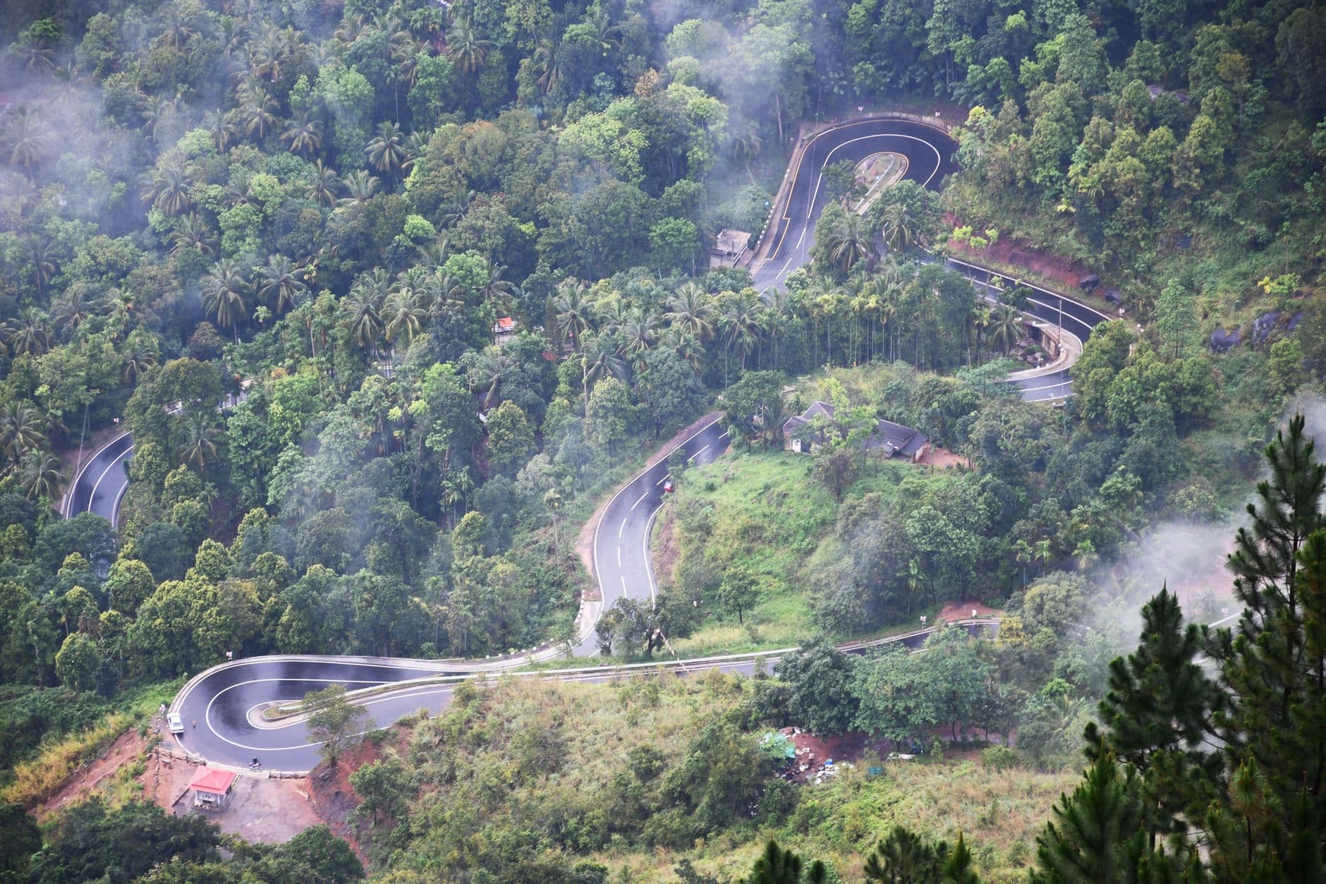 A winding mountain road through Sri Lanka's misty hills