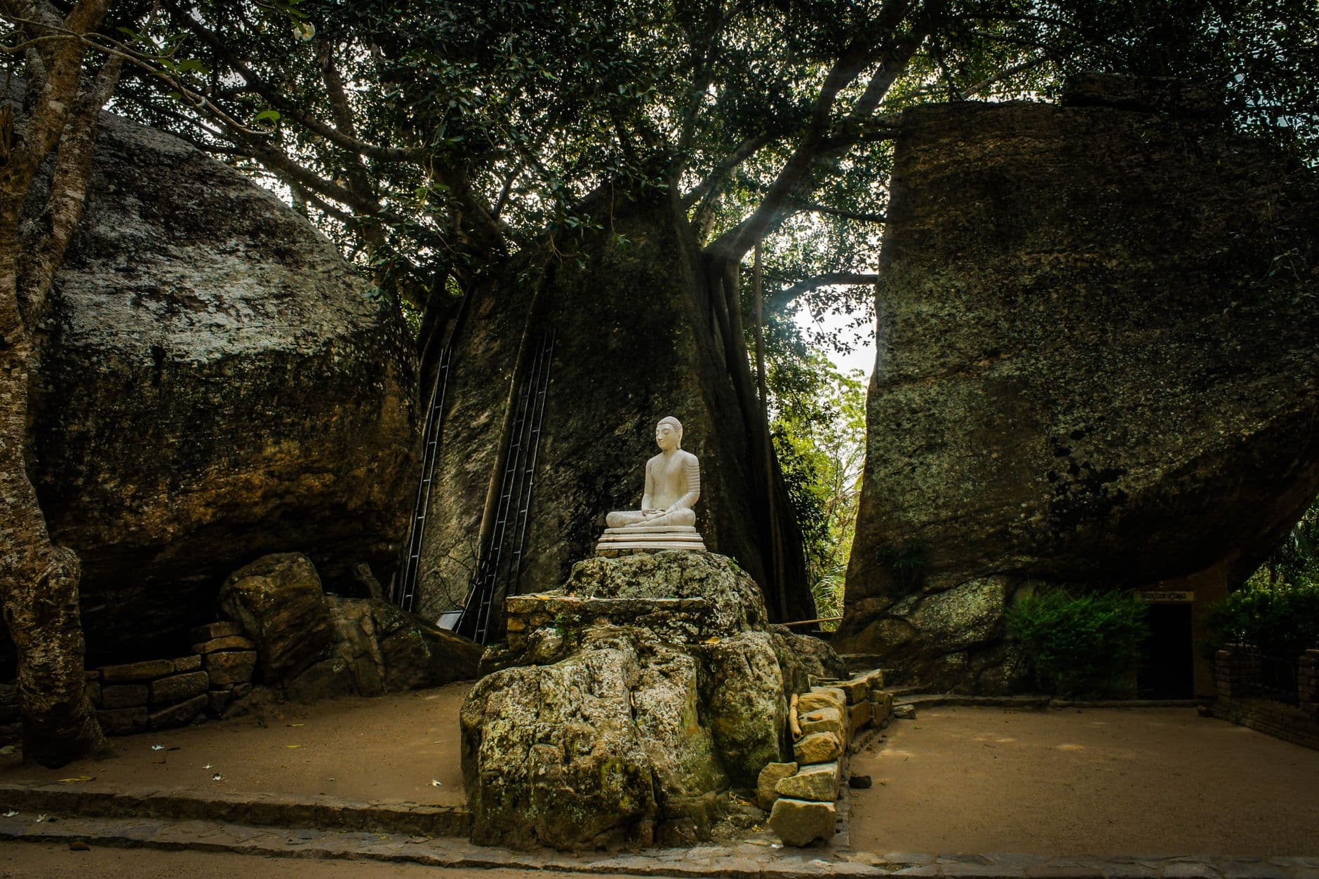 A Buddha shrine set among the boulders of a southern rock temple