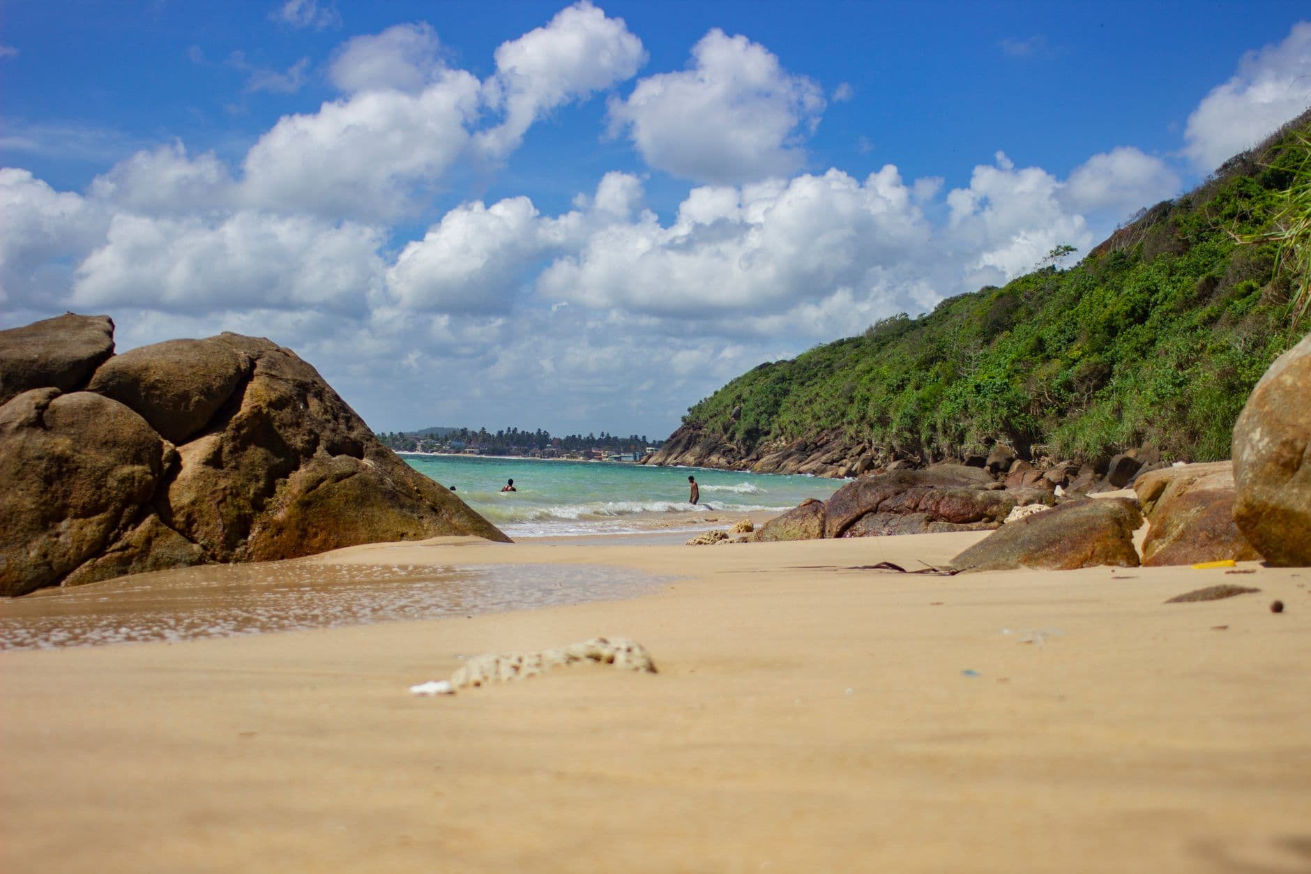 Swimmers in the calm, reef-sheltered water at Unawatuna